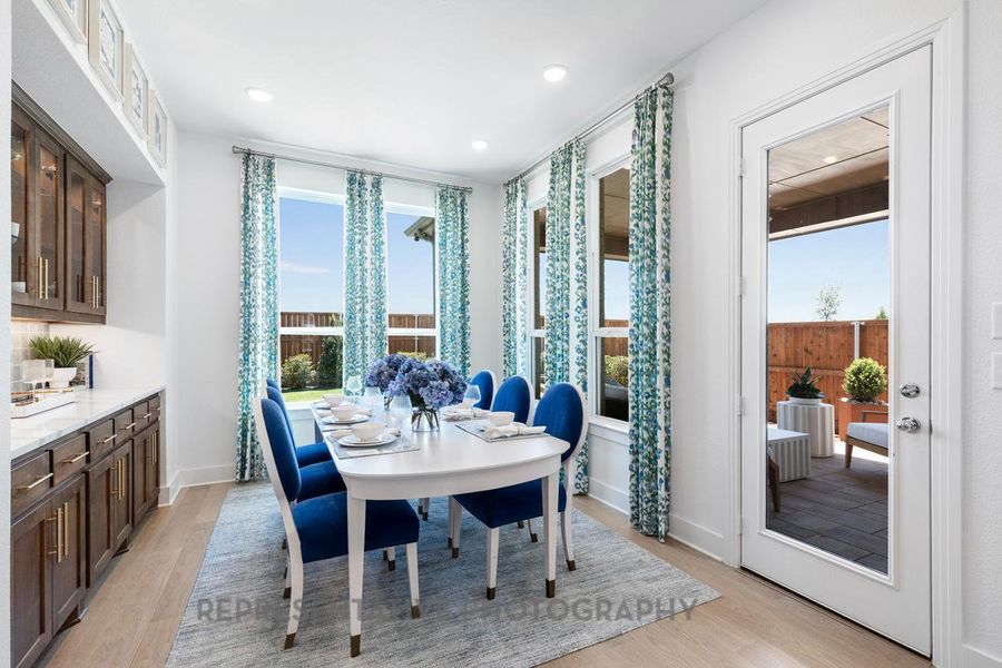 Dining space with light wood-style floors and recessed lighting
