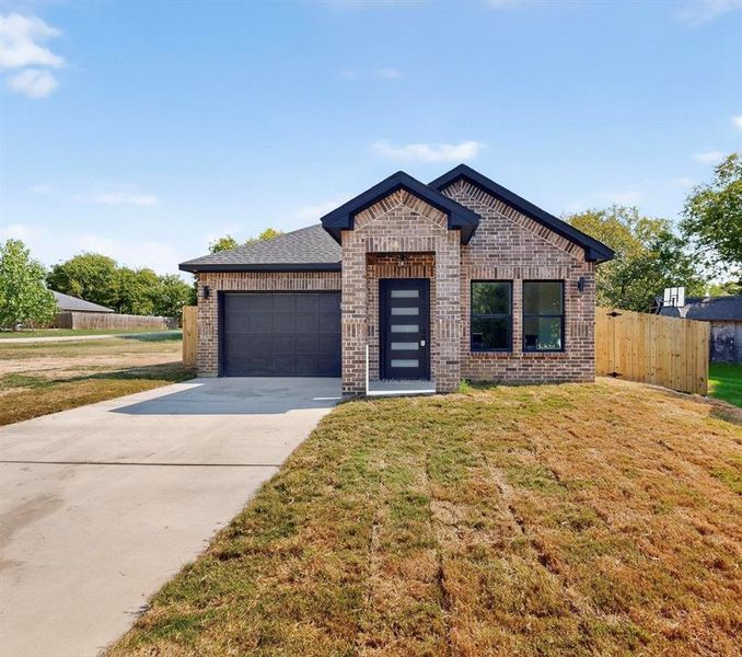 View of front of property with brick siding, an attached garage, and driveway View of front of property with brick siding, an attached garage, and driveway