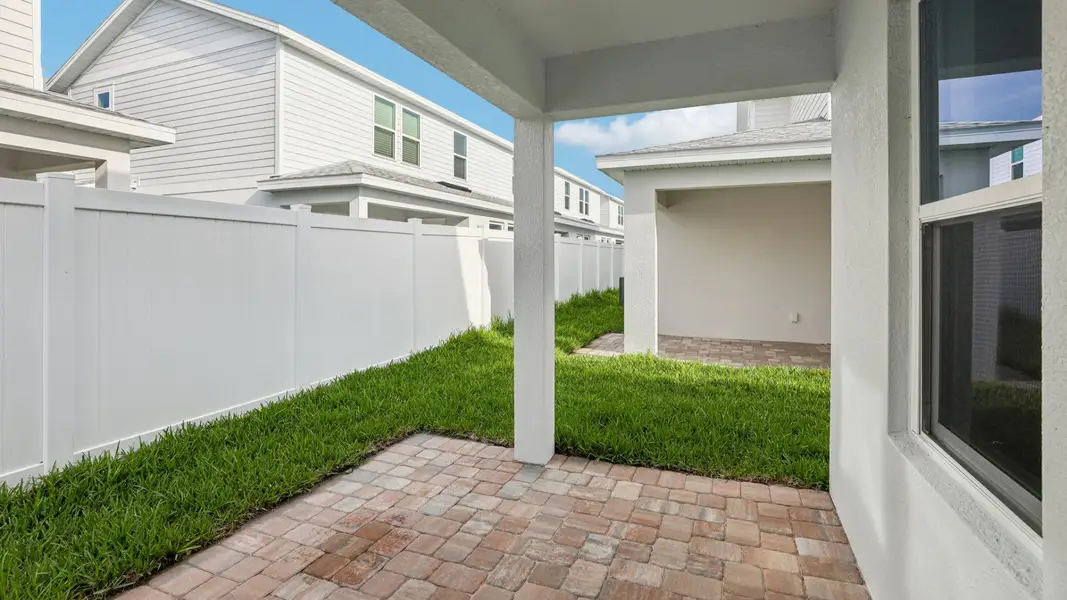 Exterior details and patio area of a home in Cyrene at Harmony, St. Cloud (Image 3).