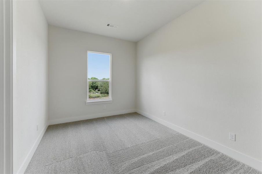 Neutral tone walls with a single window providing natural light