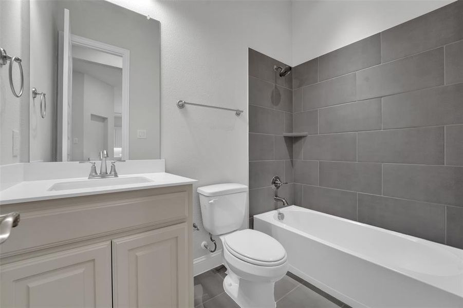 Full bathroom featuring vanity,  shower combination, and tile patterned flooring