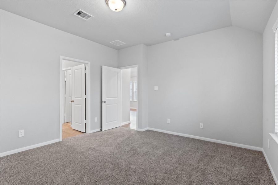The private primary suite efficiently connects the sleeping area with the dedicated bathroom and generous closet.