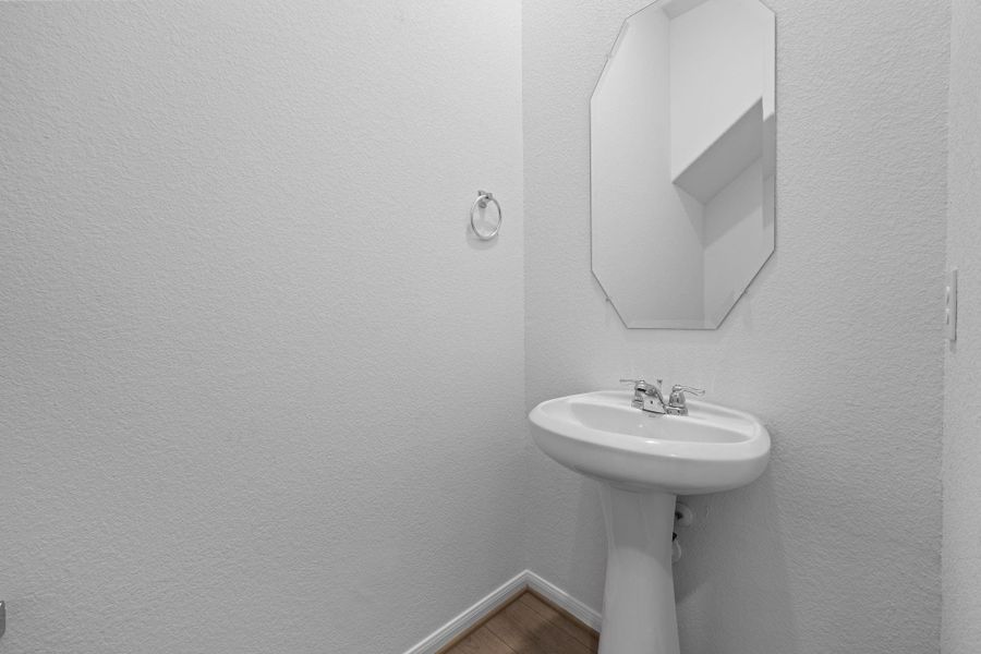 This charming home features a beautifully appointed half bath adjacent to the family room, perfect for welcoming guests and adding convenience to your daily life. This charming home features a beautifully appointed half bath adjacent to the family room, perfect for welcoming guests and adding convenience to your daily life.