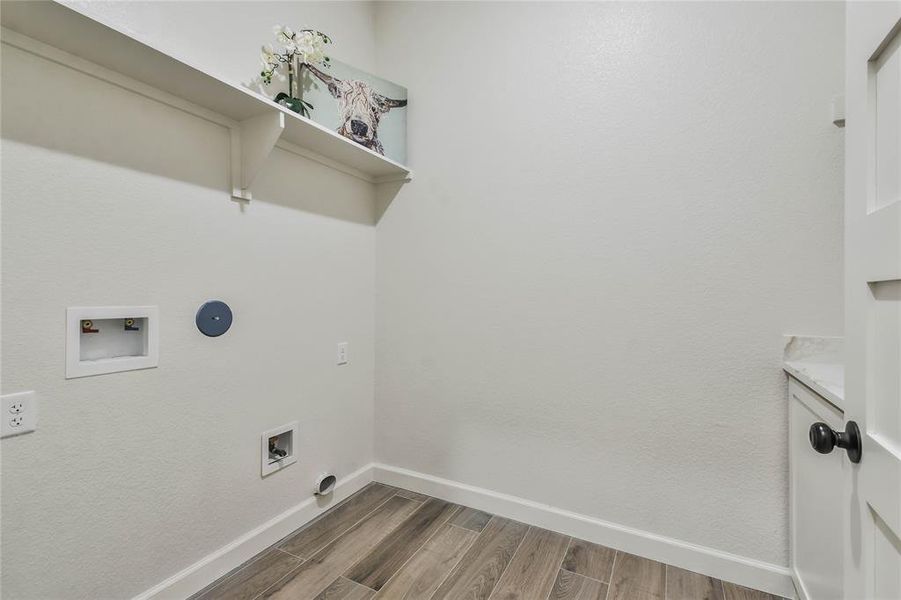 Utility room has a Quartz counter and plenty of cabinets.