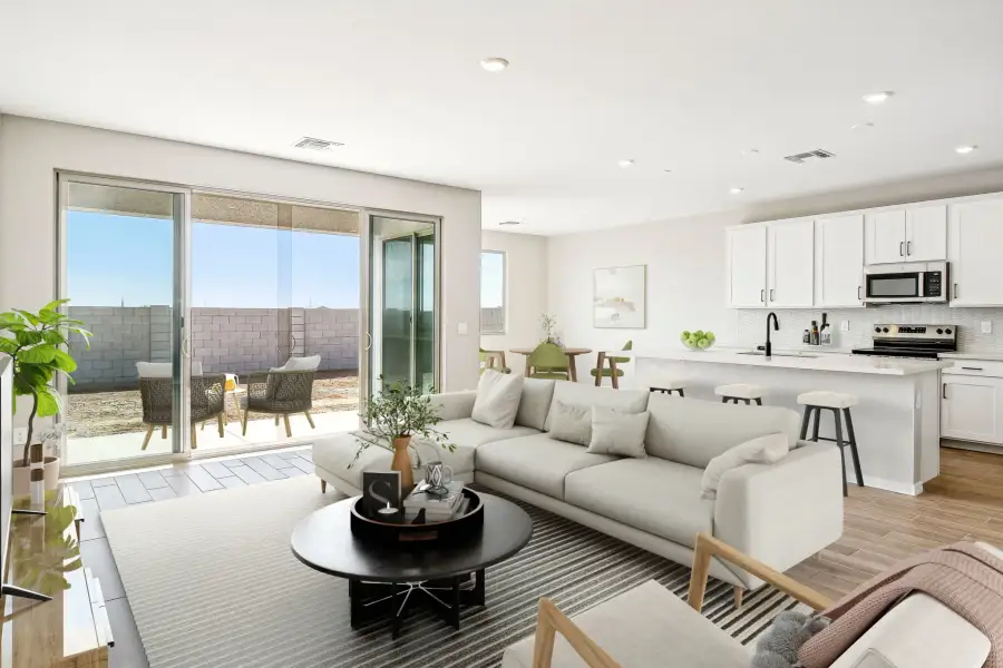 Great room and kitchen; actual finishes vary by community. This image has been digitally staged