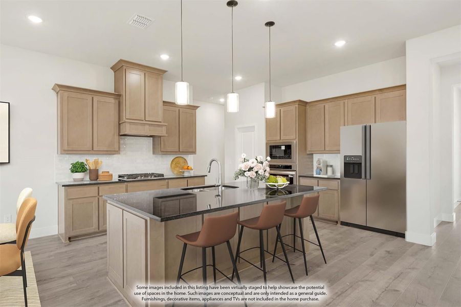 Kitchen with light wood cabinets, dark granite island with seating, stainless steel appliances, and pendant lights