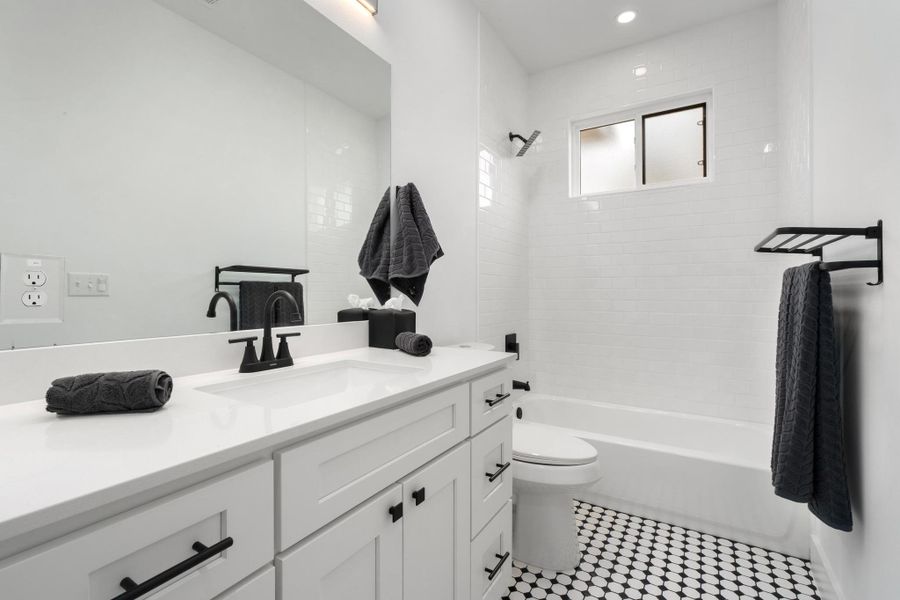 Full bath featuring vanity,  shower combination, and recessed lighting