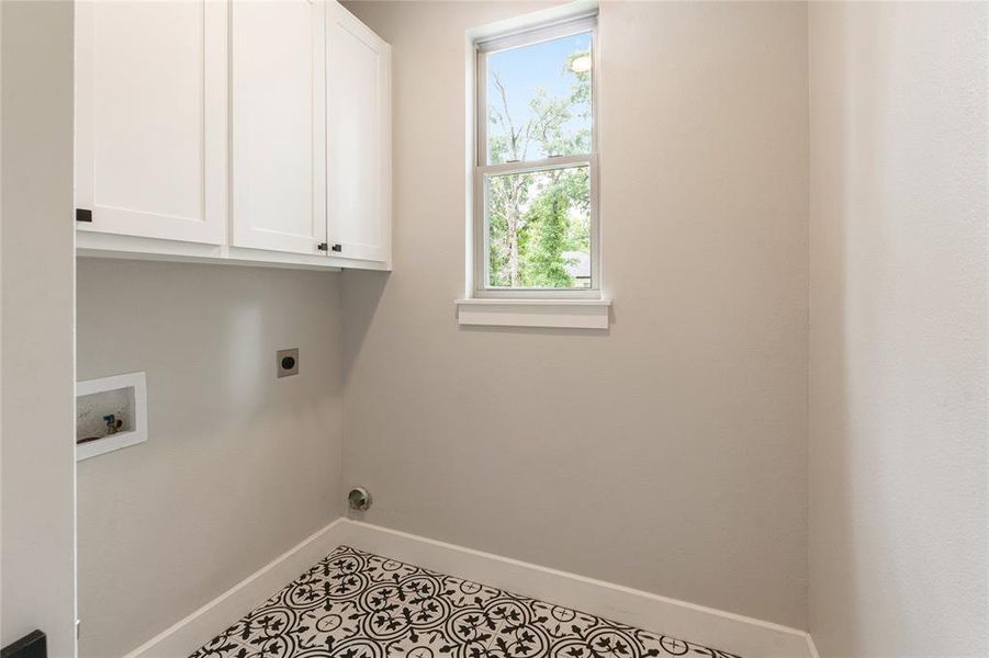 Custom cabinets, natural light, decorative tile floor Custom cabinets, natural light, decorative tile floor