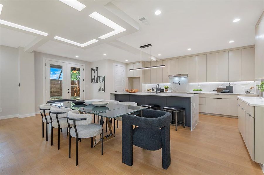 Dining area featuring sink, french doors, and light wood-type flooring