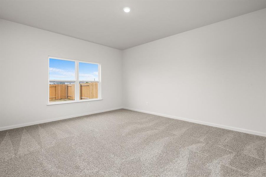 Carpeted empty room with baseboards and recessed lighting