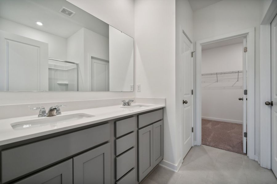 A bathroom with a sink and a shower. A bathroom with a sink and a shower.