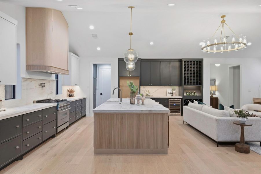 Large kitchen island offers abundant prep space, storage, and seating for everyday living and entertaining.