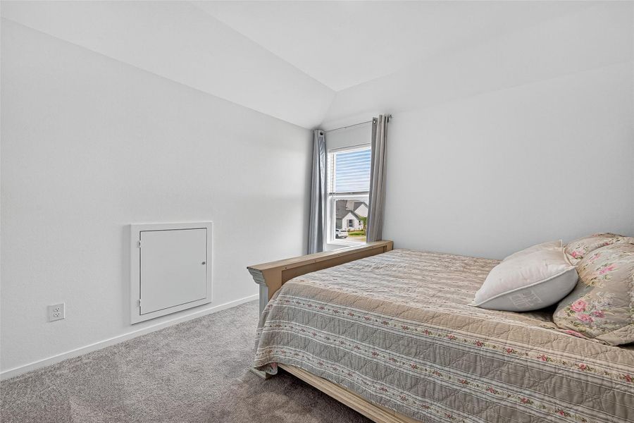 Inviting upstairs bedroom with natural light and cozy ambiance. Inviting upstairs bedroom with natural light and cozy ambiance.