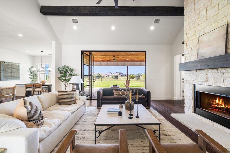 Living area with engineered wood finished floors, recessed lighting, a stone fireplace, and ceiling fan Living area with engineered wood finished floors, recessed lighting, a stone fireplace, and ceiling fan