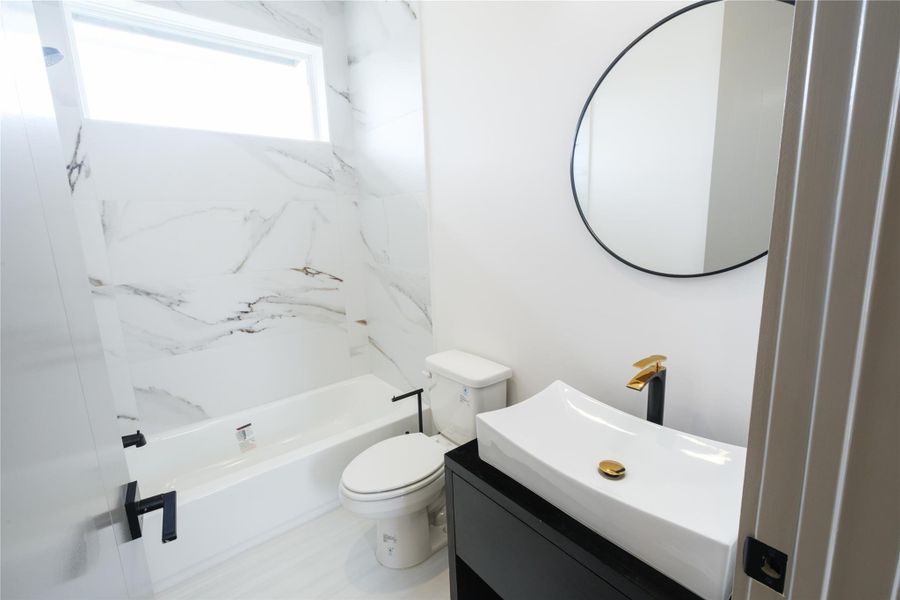 Representative Bathroom View (Design selections and colors may vary): Every full bath in the home includes custom-designed wood vanities, vessel sinks, and functional open shelving, offering continuity in design and quality.