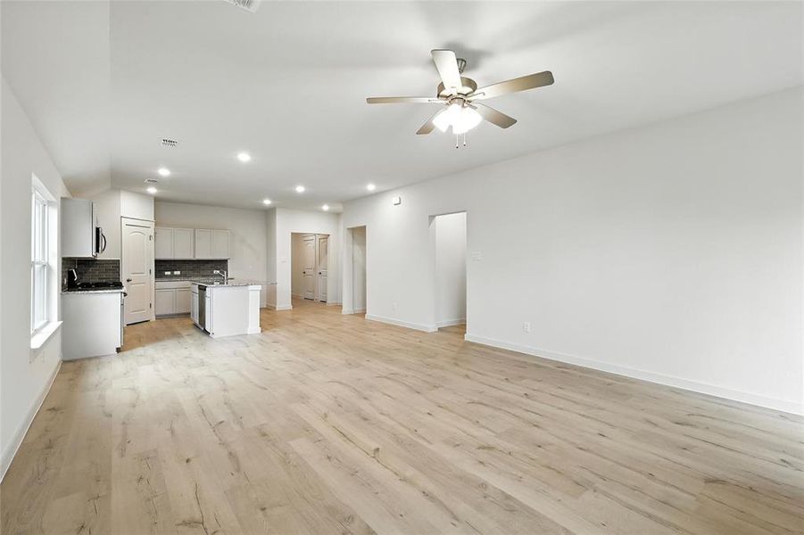 Unfurnished living room with recessed lighting, light wood finished floors, and ceiling fan
