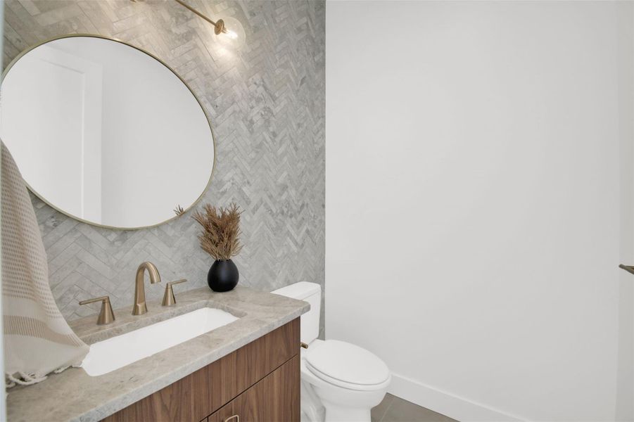 half bath/powder room featuring vanity and toilet