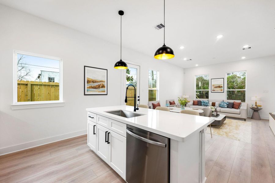 The seamless flow into the living area, complemented by large windows that flood the space with natural light, creates the perfect setting for entertaining and everyday living. The seamless flow into the living area, complemented by large windows that flood the space with natural light, creates the perfect setting for entertaining and everyday living.