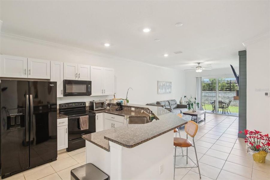 Kitchen area with view into living room. Kitchen area with view into living room.