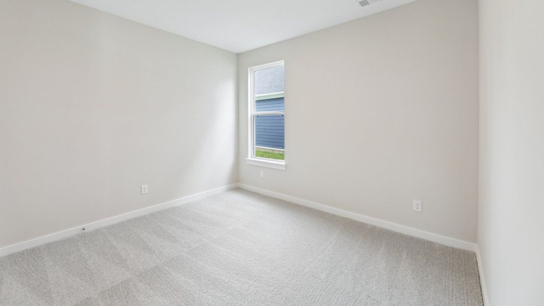 Bedroom with window and carpet