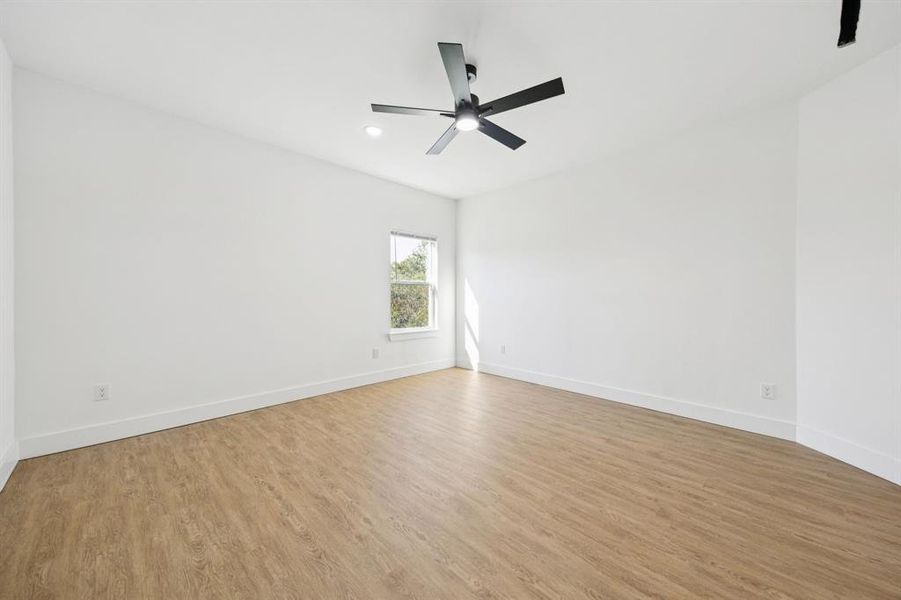 Empty room featuring light wood-type flooring, recessed lighting, and a ceiling fan