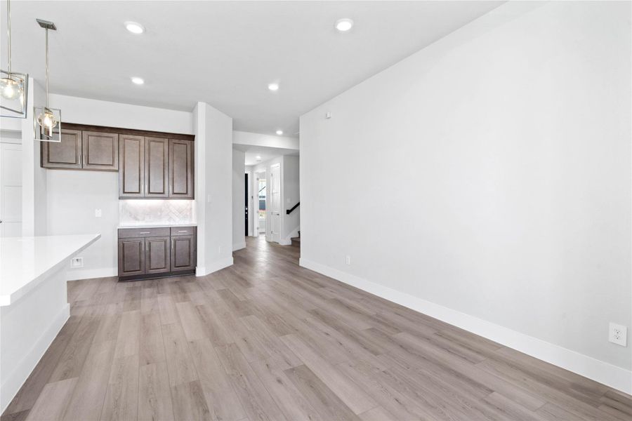 This dining area is a natural extension of the kitchen and living room, allowing for seamless conversation and connection with guests or family members, even when preparing a meal.