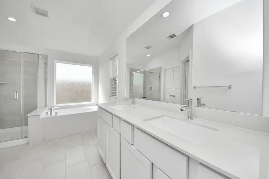 Elevate your daily routine at the elegant vanity, now equipped with double sinks, light countertops, modern hardware, and beautiful recessed lights. Elevate your daily routine at the elegant vanity, now equipped with double sinks, light countertops, modern hardware, and beautiful recessed lights.