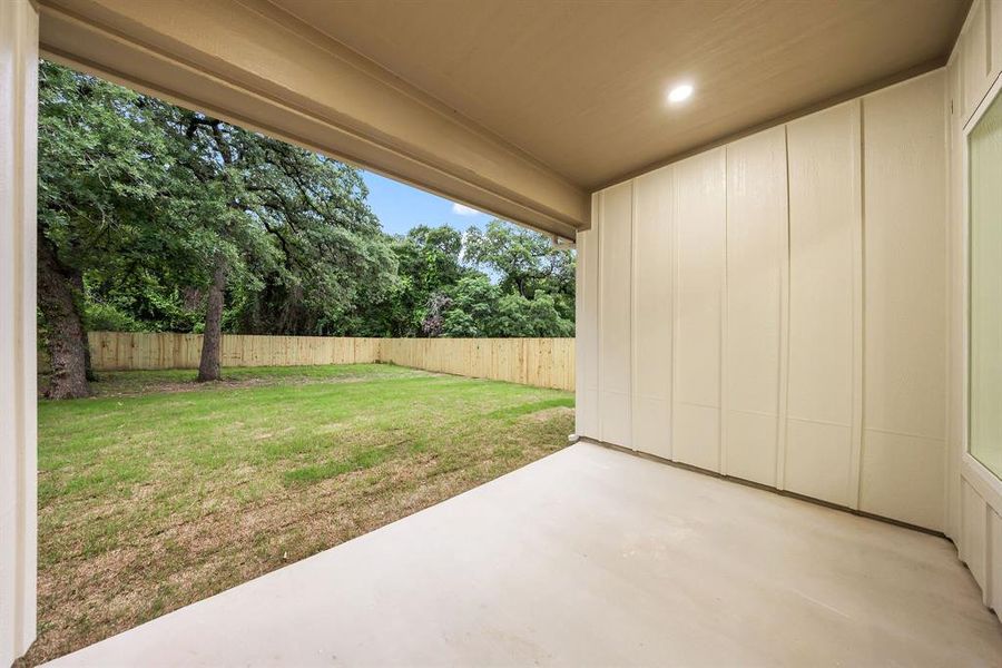 Covered patio with recessed lighting, concrete flooring, and a board and batten wall
