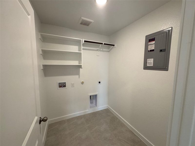 Washroom featuring hookup for a gas dryer, hookup for an electric dryer, electric panel, and hookup for a washing machine Washroom featuring hookup for a gas dryer, hookup for an electric dryer, electric panel, and hookup for a washing machine