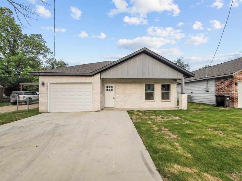 View of front of home featuring brick siding, driveway, a garage, a front yard, and a shingled roof View of front of home featuring brick siding, driveway, a garage, a front yard, and a shingled roof