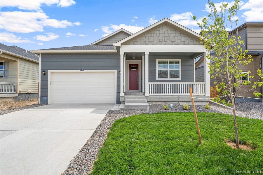 Front exterior of a new home in Spring Valley Ranch, Elizabeth, CO, highlighting curb appeal (Image 20).