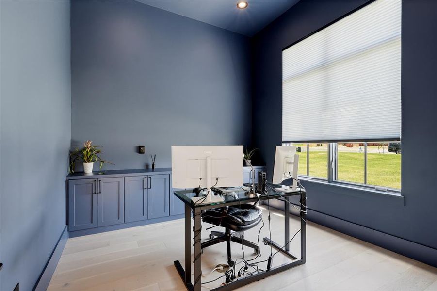 Dedicated office space featuring built-in cabinetry, recessed lighting, and light wood-finish flooring