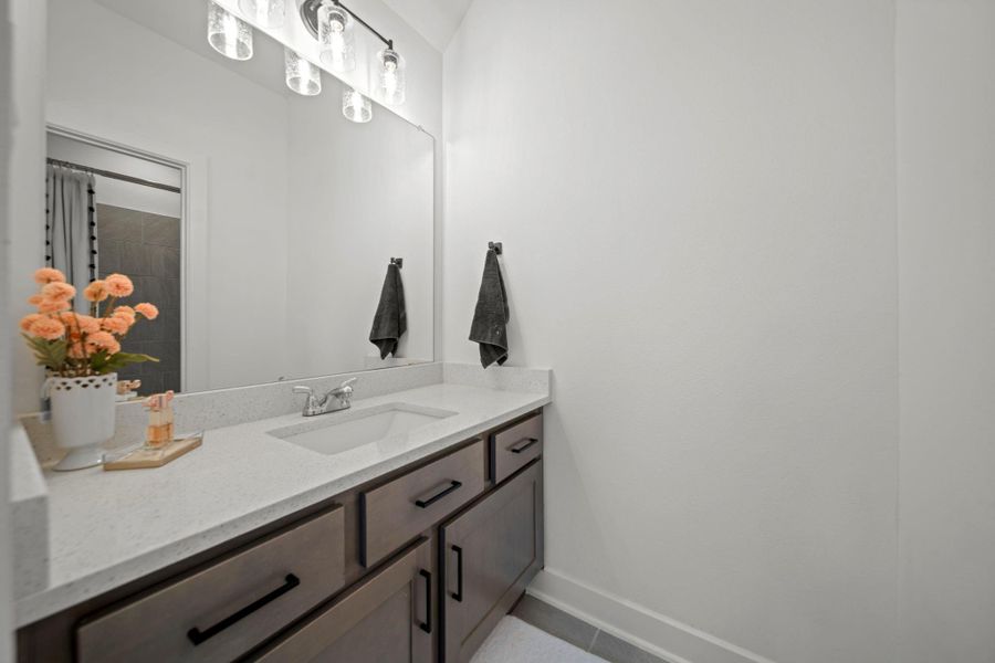 Neutral vanity in Jack and Jill bath setup with rich cabinetry and modern lighting—a stylish and practical bathroom design. Neutral vanity in Jack and Jill bath setup with rich cabinetry and modern lighting—a stylish and practical bathroom design.