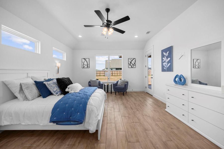 Bedroom with light wood-style flooring, access to outside, a ceiling fan, and recessed lighting