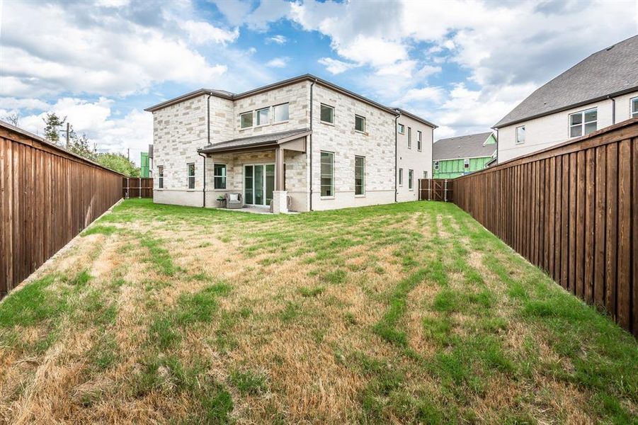 Back of house featuring a yard