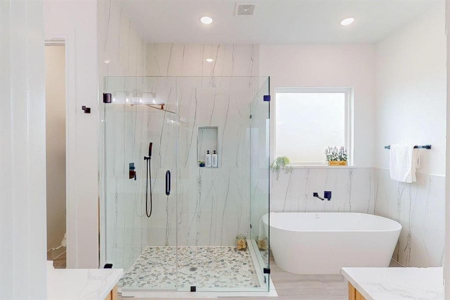 Main Bathroom with vanity, independent shower and bath, and tile walls