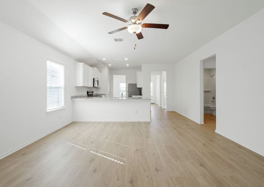 Family room and adjoining kitchen with vinyl flooring