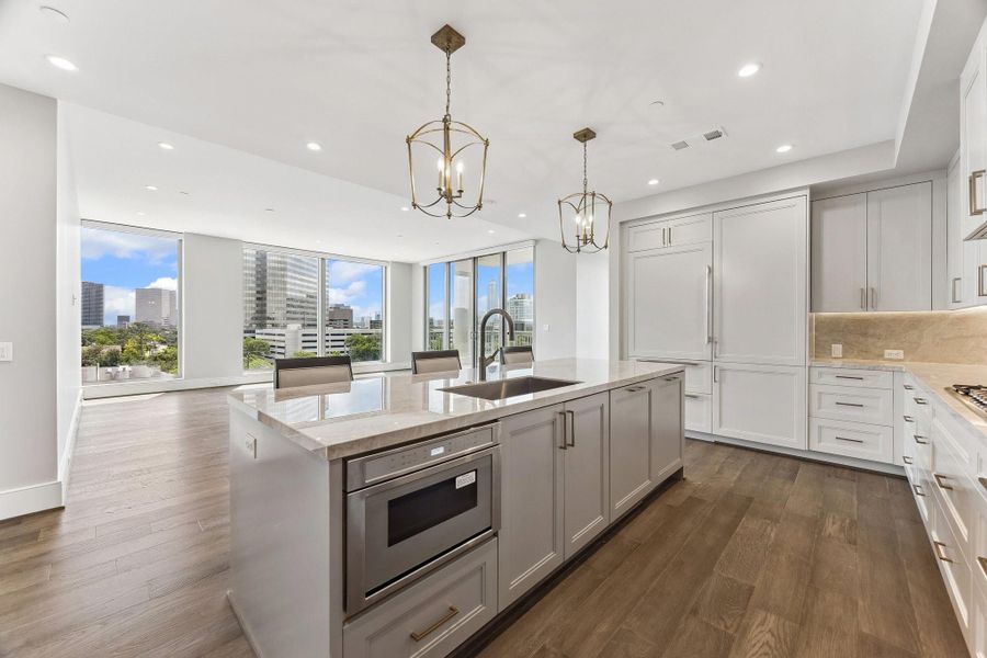 The ideal entertainer's layout space perfectly blends kitchen with living room so you never miss a moment with your guests