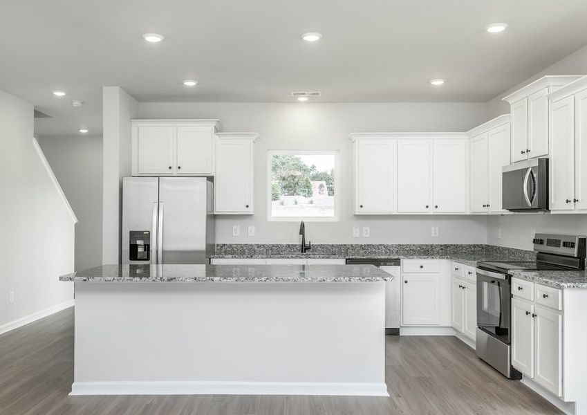 The kitchen has designer wood cabinetry