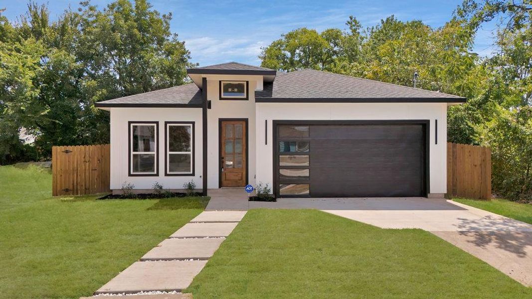 Prairie-style house with a garage and a front lawn