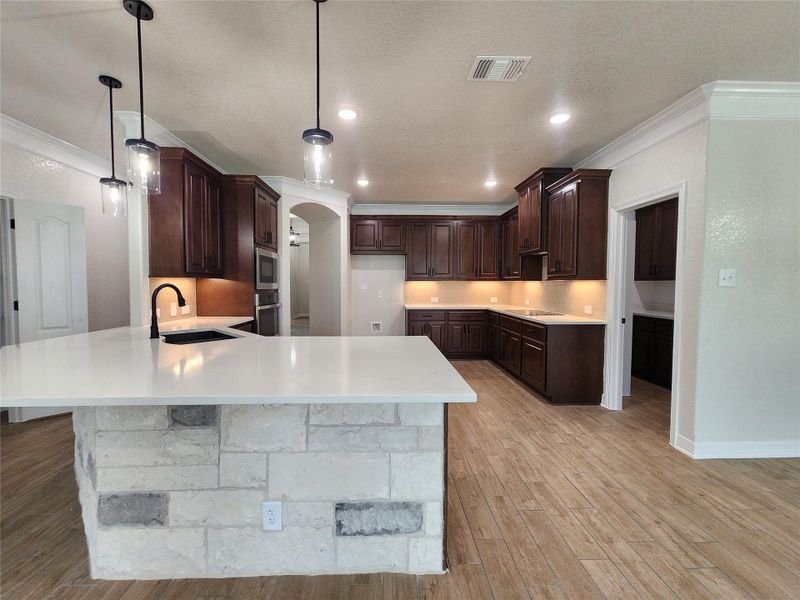 A grand central island anchors this gourmet kitchen, perfect for entertaining. A grand central island anchors this gourmet kitchen, perfect for entertaining.