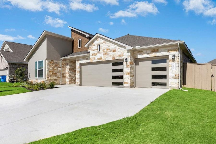 Front exterior of a new home in The Colony, Bastrop, TX, highlighting curb appeal (Image 2).