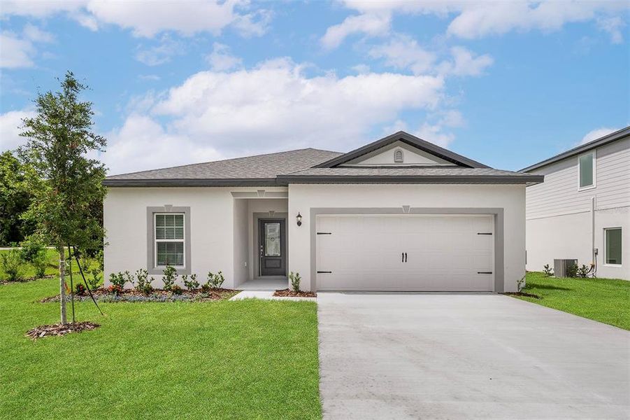 Front exterior of a new home in Tula Parc, Astatula, FL, highlighting curb appeal (Image 2).
