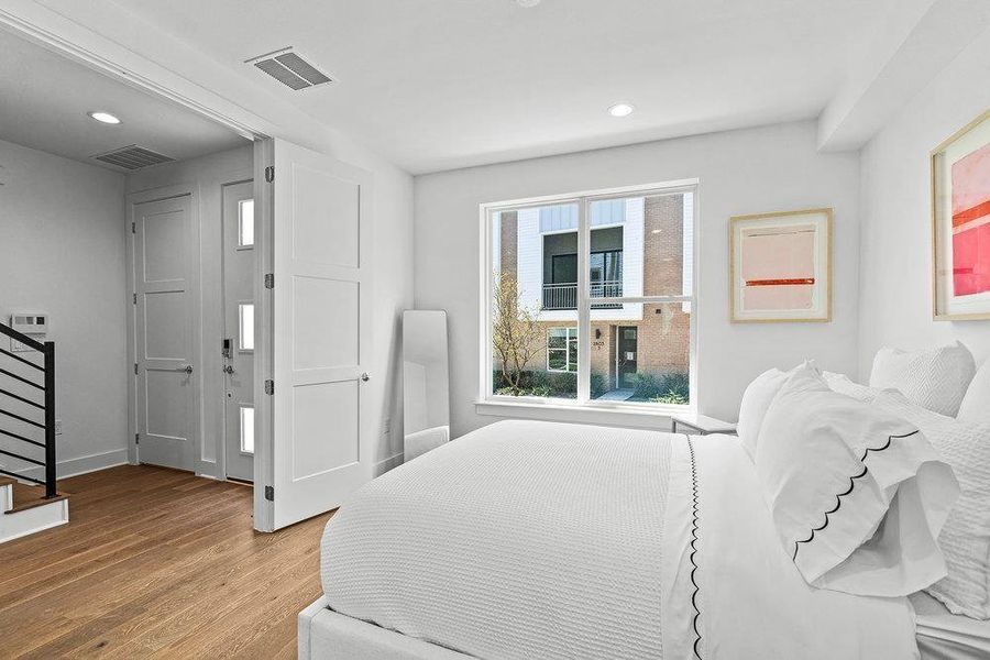 Bedroom featuring wood finished floors and recessed lighting