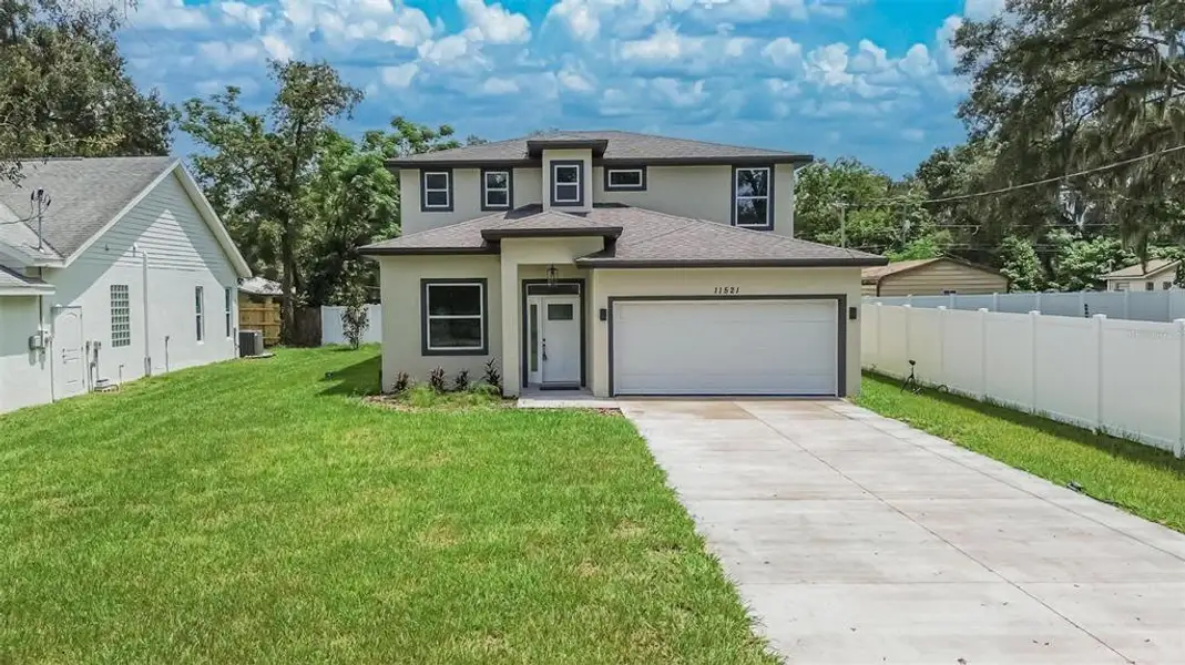 Front exterior of a new home in , Thonotosassa, FL, highlighting curb appeal (Image 19). Front exterior of a new home in , Thonotosassa, FL, highlighting curb appeal (Image 19).