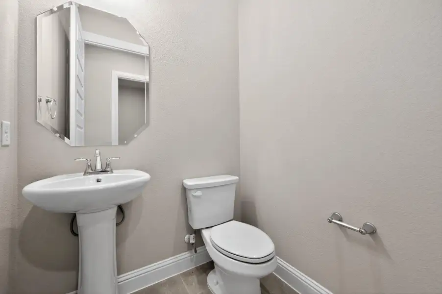 Half bath featuring a textured wall