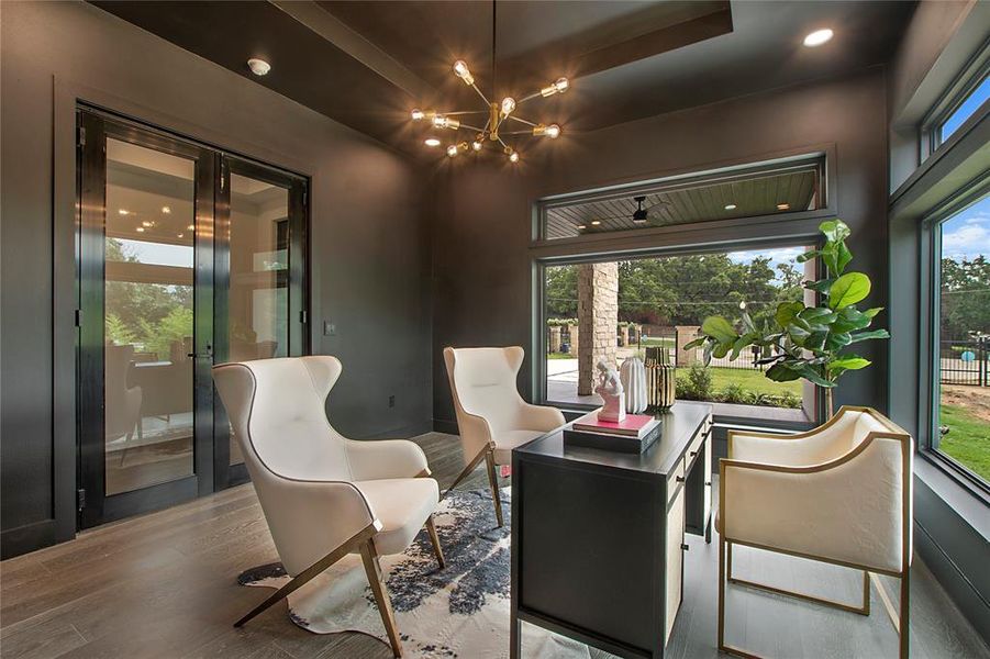 Dining space with a notable chandelier and wood-type flooring