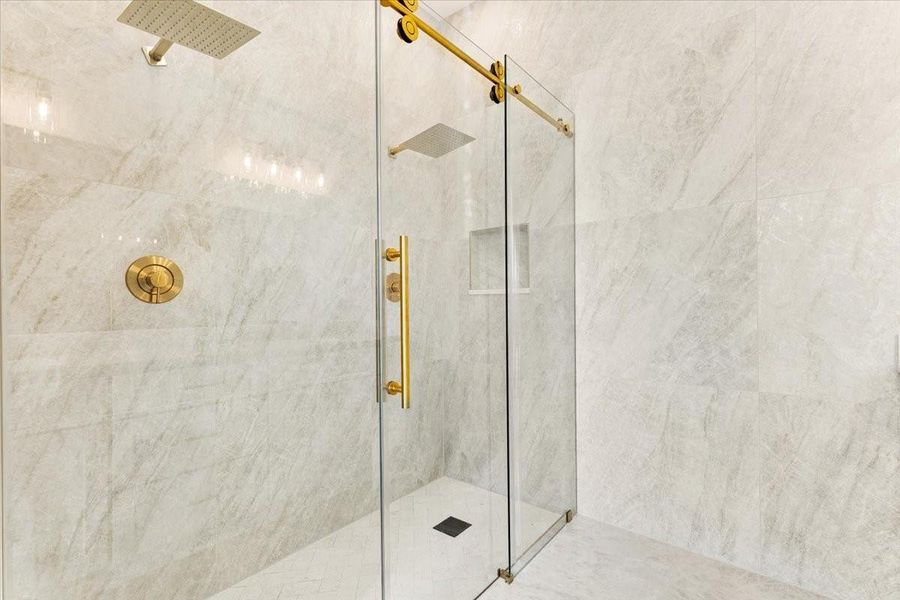 Alternative view of the walk-in shower showcasing stylish tile work and glass enclosure. Alternative view of the walk-in shower showcasing stylish tile work and glass enclosure.