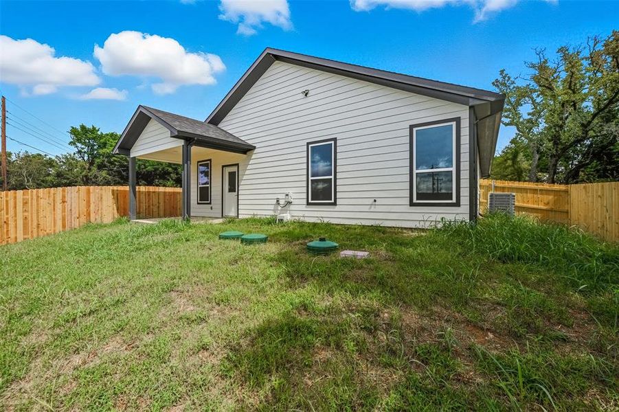 Rear view of house with a fenced backyard and a patio Rear view of house with a fenced backyard and a patio