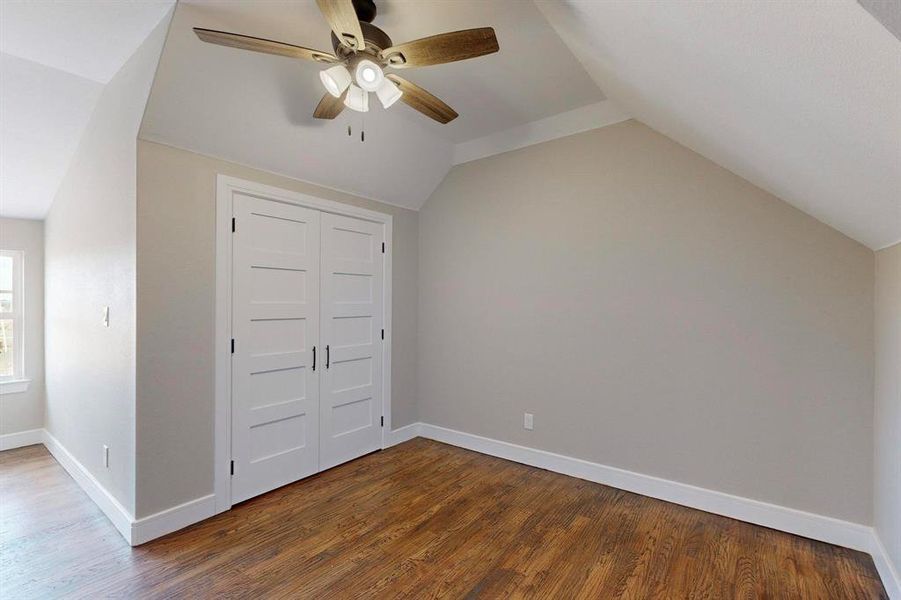 Bonus room featuring wood-type flooring, vaulted ceiling, and ceiling fan